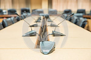 Before a conference, the microphones in front of empty chairs. S