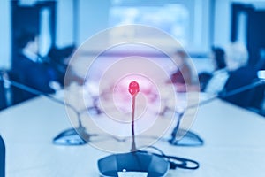 Conference microphones on the table over blurred of attendee in meeting room background