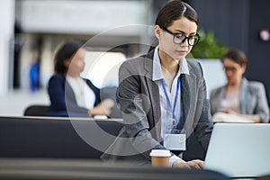 Conference participant checking presentation on laptop