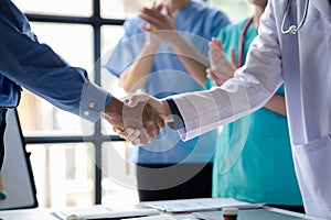 Conference room in the hospital, a group of doctors attending a handshake meeting, a meeting of executive doctors and chiefs