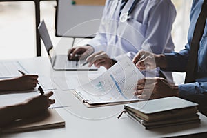 A conference room in a hospital where a group of doctors are attending a meeting, a meeting of executive doctors and chiefs