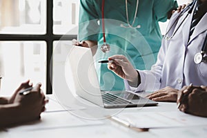 A conference room in a hospital where a group of doctors are attending a meeting, a meeting of executive doctors and chiefs