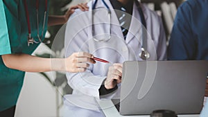 A conference room in a hospital where a group of doctors are attending a meeting, a meeting of executive doctors and chiefs