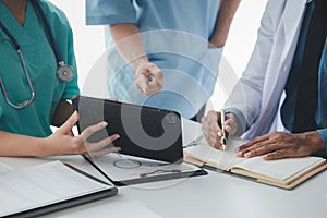 A conference room in a hospital where a group of doctors are attending a meeting, a meeting of executive doctors and chiefs