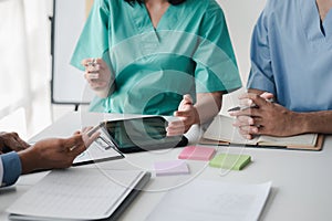 A conference room in a hospital where a group of doctors are attending a meeting, a meeting of executive doctors and chiefs