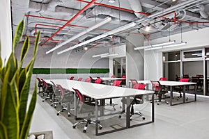 Conference room interior with empty chairs and a projector screen