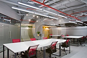 Conference room interior with empty chairs and a projector screen photo