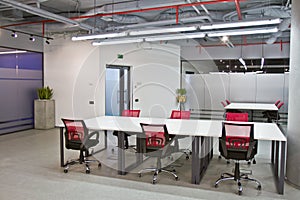 Conference room interior with empty chairs and a projector screen photo