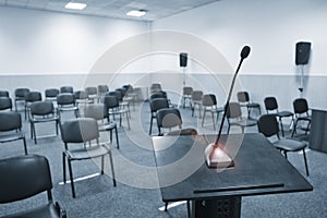 Conference table, microphones and office chairs close-up