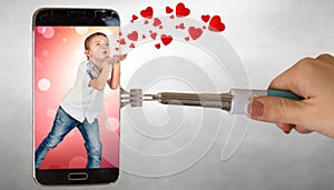 Confession in love. The boy sends hearts through the phone screen .