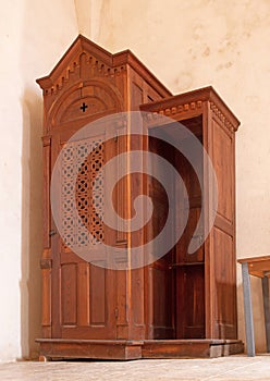 Confessional Box or Booth, a wooden cabinet or stall where the Priest presides over confession photo