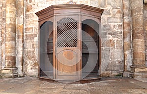 Confessional Box or Booth, a wooden cabinet or stall where the Priest presides over confession photo