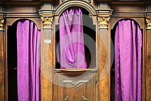 Confessional with purple curtains photo