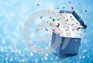 Confetti popping out from blue gift box