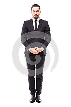 Confidence and charisma. Full length of smiling young bearded man in formalwear keeping hands crossed and looking at camera agains