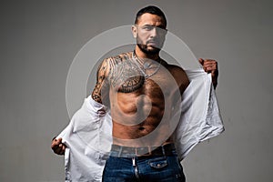 Confidence charisma. muscular macho man with athletic body. sport and fitness, health. sexy abs of tattoo man. male