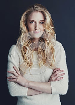 Confidence is her best feature. Studio portrait of a smiling young woman isolated on black.