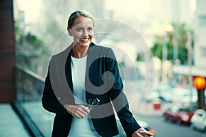 Confidence, an important business asset. Portrait of a mature businesswoman standing outside on the balcony of her