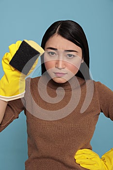 Confidence serious asian young houseworker from chores