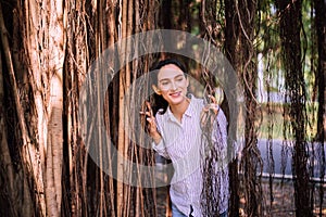 Confidence woman standing and looking something at park,Happy and smiling,Positive thinking,Relaxing time