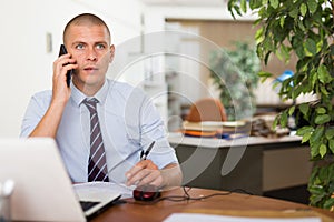 Confident adult man working at office
