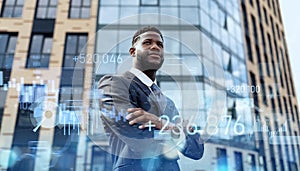 Confident African American businessman standing outdoors with digital financial graphics