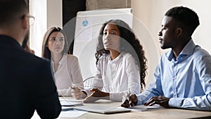 Confident African American businesswoman speaking at corporate meeting in boardroom