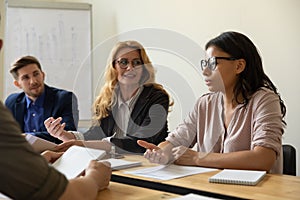 Confident African American employee, team leader speaking on corporate meeting