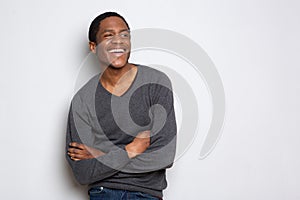Confident african american man smiling with arms crossed against white background