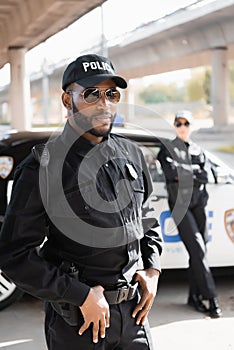 Confident african american policeman looking at