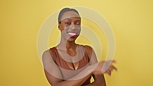 Confident african american woman flashing a winning smile and playful wink, standing with happy face, showing victory sign, all