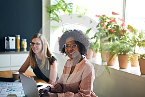 Confident African businesswoman working with a colleague in an o