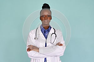 Confident african female doctor looking at camera on mint background, portrait.