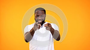 Confident afro-american man pointing fingers camera, choice gesture, flirt sign