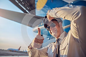 Confident air captain showing like while standing in the outdoors