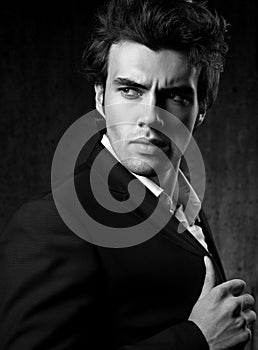 Confident ambitious handsome man with strained look posing in fa