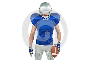 Confident American football player looking down