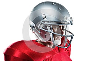 Confident American football player in red jersey looking away