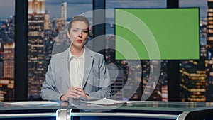 Confident anchorwoman delivering latest news at stage with mockup tv closeup