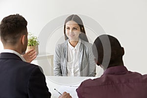 Confident applicant smiling at job interview with diverse hr man