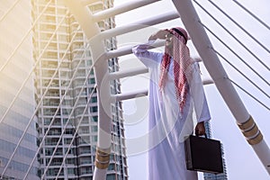 Confident Arabian Businessman standing and looking at city background for vision concept