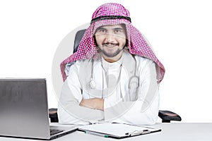 Confident Arabian doctor smiling at camera