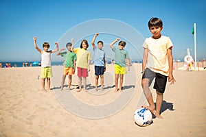 Confident Arabic boy standing with soccer ball