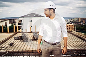 Confident architect, engineer on building construction site