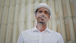 Confident architect looking camera urban walls background portrait. Man posing