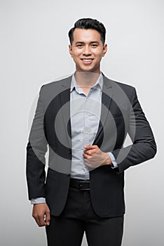 Confident Asian businessman smiling and looking at the camera