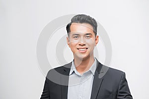 Confident Asian businessman smiling and looking at the camera