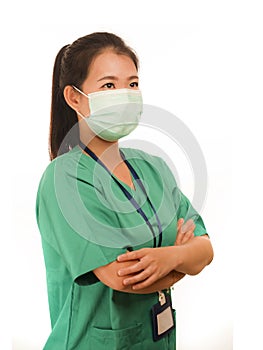 Confident Asian Chinese medicine doctor woman or hospital nurse in green scrubs and surgical protective face mask in protection