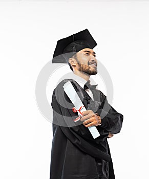 Confident asian male graduate wearing toga and holding certificate paper