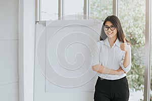 Confident Asian woman with blank flipchart photo